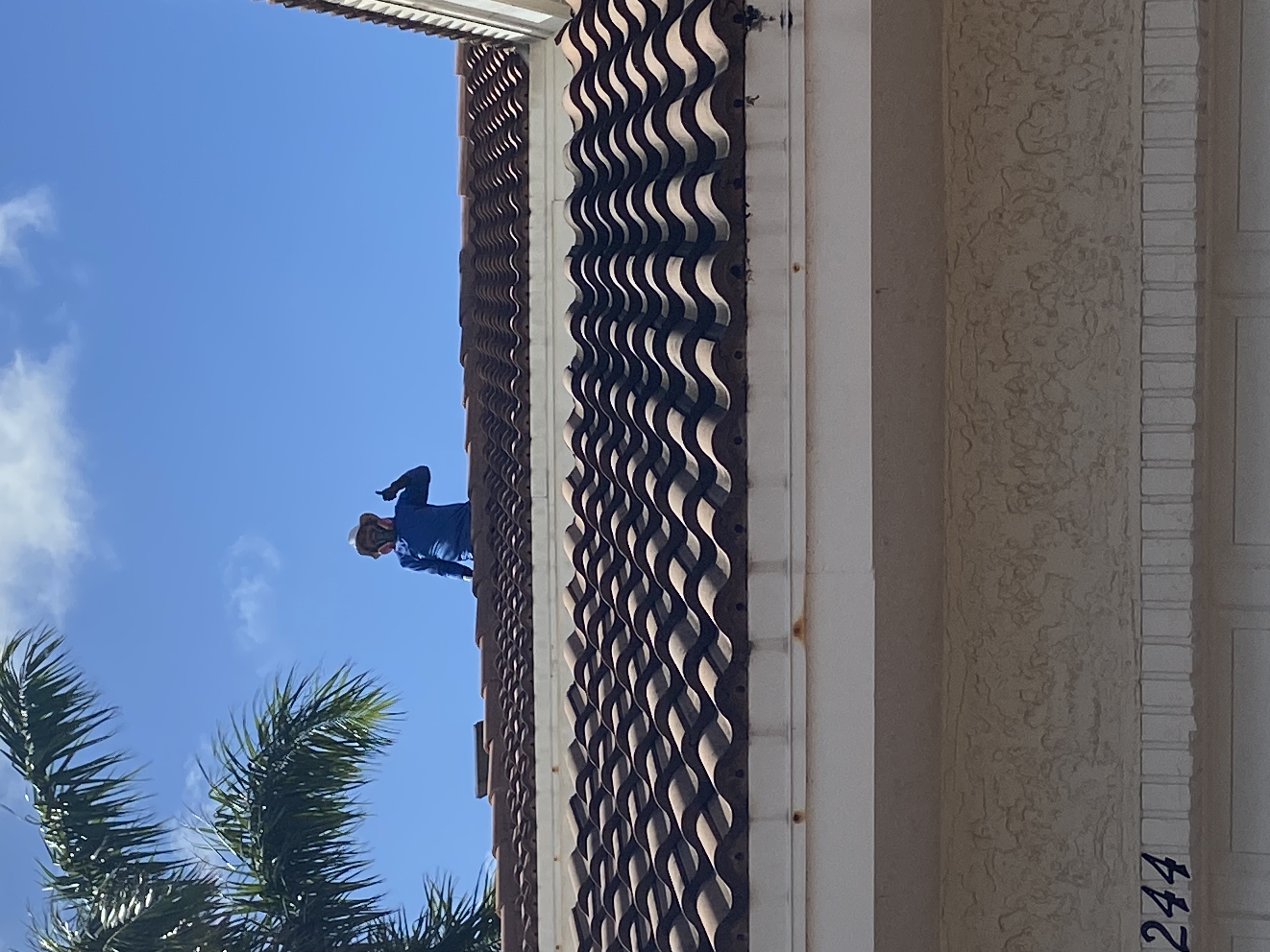 Perfect two story home roof soft wash cleaning in port Salerno, Stuart Florida.